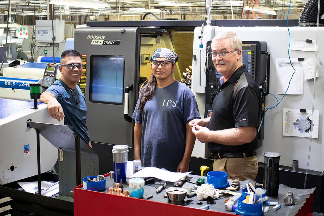 Engineer Discussing Quality With Machine Operators